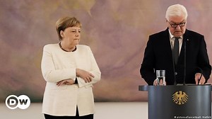 Merkel visibly shaking during ceremony