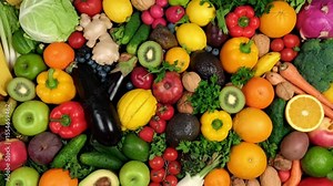 Colorful assortment of fresh fruits and vegetables creates a vibrant and nutritious food background for healthy eating concept.