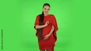 Pretty young woman confused saying oops and shrugging. Green screen