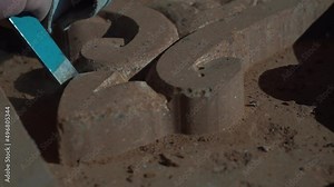 Sculptor working with chisel on stone. Craftsman hand working with stone. Stonemason working with his tools. Carving stone, craftsman shaping stone, art and crafts.