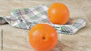 Slices of orange appearing on a countertop and becoming whole, stop motion animation