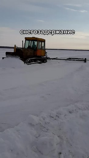 Snow Plowing with a Yellow Snowplow in Action