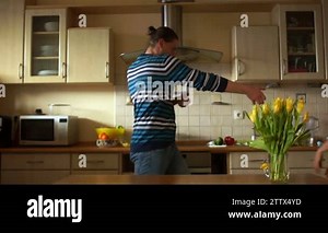 Husband and wife, a loving couple fooling around in the kitchen. Depict pantomime, all fools day Stock Video Footage - Alamy