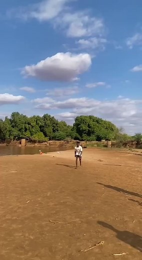 Acrobatic Stunts on the Riverbank by Young Performers