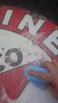cleaning up a porcelain sign