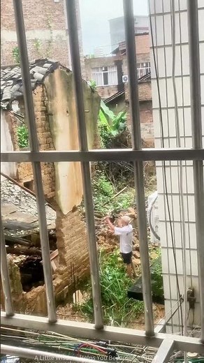 Demolition of an Old House: Worker Hammers Brick Wall with Tools, Scene in Chaos