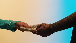 Man in medieval ages gives wad of money for the goods. Stock. Concept of trade in the middle ages