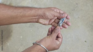 Using a nail clipper to cut the nails. Clipping and polishing nails