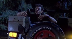 Life finds a way: person dressed as T-Rex chases a Jurassic Park SUV