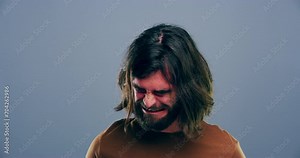 Sad, grief and young man crying in a studio with upset, worry and depression face expression. Emotions, bad news and male person from Australia with tears for broken heart isolated by gray background
