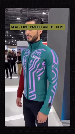 AI War Room on Instagram: "Imagine the military application for this! A jacket that changes color in real time. AeroSkin’s Chameleon Jacket adapts its surface using advanced materials that shift appearance to match the environment. This tech demo, shown at GITEX 2029, hints at future uses far beyond fashion. Imagine camouflage that reacts instantly to light, movement, or terrain."