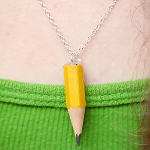 Teachers, English majors and artists will love this set of pencil jewelry. ✏️ If you have jewelry-making supplies, feel free to swap the hot glue for an eye-hook when creating your set. | HGTV Home