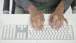 Free stock video - Top view of lady typing on keyboard