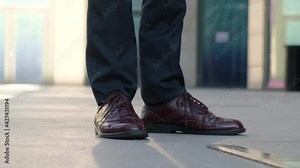 Late and excitement before the meeting concept.Man tapping his shoes while waiting for someone, close-up