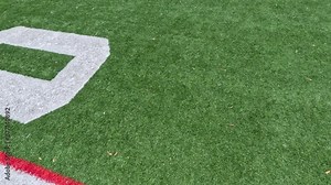 Football Field Turf in Motion. Moving across the 50 yard line on a soccer or football field. Green artificial turf surface background.