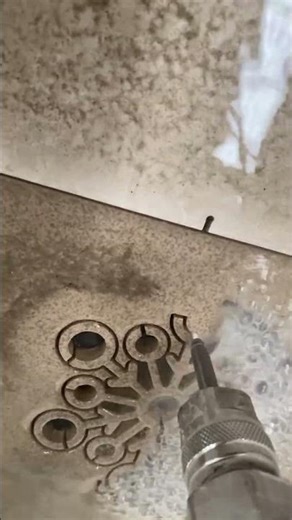 CNC machine making water jet cutting pattern on granite
