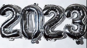 Stop motion Happy new year 2023 metallic balloons on white background. Greeting card silver foil balloons numbers Christmas holiday concept. Celebration party congratulation decoration