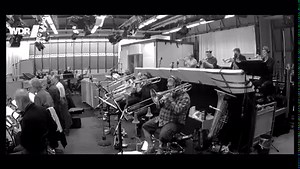 First name Bob, last name Mintzer; our "Principal Conductor" and a sax player that really needs no further introduction! Tonight we're streaming live from the Kölner Philharmonie . Bob has brought a veritable boquet of tunes, oscillating on a Latin Jazz tangent. Here's a taste of what the evening will bring, Bob's tune "Just A Thought", featuring himself on tenor sax, ben Fitzpatrick on tenor sax and Billy Test on piano, with special guest Sebastian Nickoll on congas. Recorded live in Studio 4, 