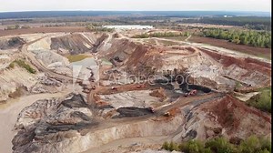 Extraction of iron ore, copper, gypsum. Opencast mining quarry with lots of machinery trucks. Open pit mine coal mining quarry. Excavators and dumpers are loading minerals at industrial quarry