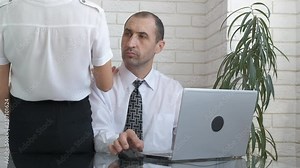 Flirting at work. A woman flirts with a man in the office.