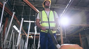 Active worker man walking and pushing hand pallet truck while working in heavy manufacturing. Industry and Factory plant.