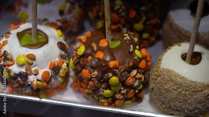 Toffee apples, also known as candy apples in North America, are whole apples covered in a hard toffee, chocolate and/or sugar candy coating with a stick inserted as a handle.