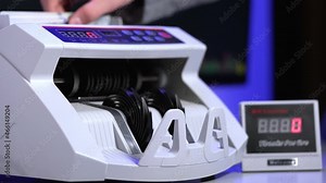 Counting operation on electronic cash machine. Counting money on bank automatic equipment. Paper banknotes in modern money counting machine. Investment capital operations.