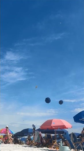 Sudden Dust Devil Sweeps Beach and Sends Umbrellas Flying