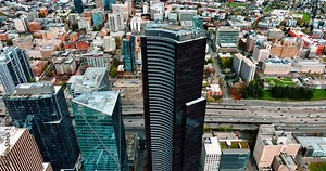 Beautiful modern high-rise buildings in the downtown of Seattle, Washington State, the USA. Busy highway with lively traffic at backdrop. Top view.