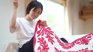 A woman making a Hawaiian quilt