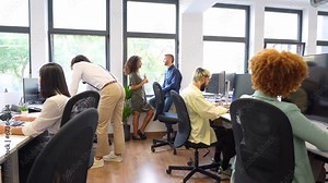 Coworkers using computer together and smiling looking the screen