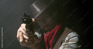 Portrait of a tough wild west cowboy aiming his gun, smoking a cigar, 4k Stock Video