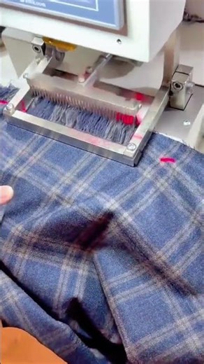 testing the quality of a plaid fabric material using an automated textile machine in a factory