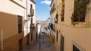 Cáceres Old Town street view with traditional Spanish buildings and plants