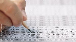 Student take exam choice with hands and write the exam test answer sheet with pencil,Answering test questions on the exam concept