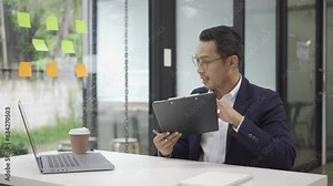 Smiling asian male accountant working on desk calculating annual financial paperwork tax using calculator executive manager sitting at desk in office examining company financial accounting paperwork