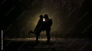 Couple kissing in the dark night
