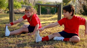 Premium stock video - Kids performing stretching exercise in boot camp