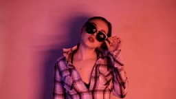 Brunette girl in the neon lights of lights. Portrait.
