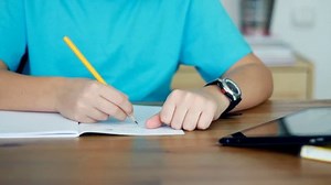 Boy hands doing homework using tablet computer