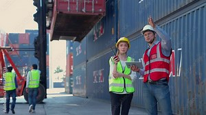 Officers in multi-ethnic logistics team both women and men work together inspect container loading controls to prepare shipments cargo at industrial ports at commercial shipment to export and import.