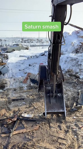 Demolition of a Car in Snowy Junkyard Scene