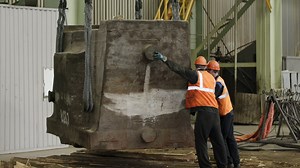 Workers lifting a heavy metal object using a crane Premium Stock Video Footage