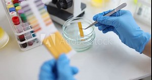 Scientist chemist checking acidity of liquid with litmus paper in laboratory closeup 4k movie. Chemical education concept