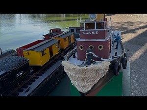 RC tug boat with railway barge at Spreckels Lake, San Francisco