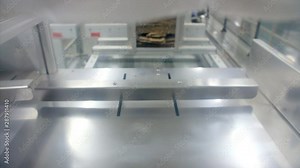 Shot of an automatic machine carrying packed thread spool.