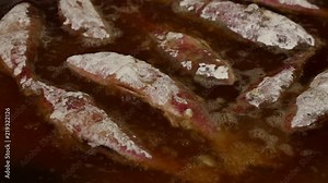 Close up cooking deep fried red mullet fish in oil