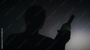 Stressed female drinking wine from a bottle, alcohol addiction, personal crisis