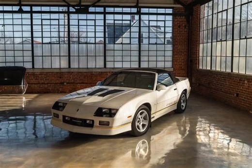 1989 Chevrolet Camaro IROC-Z Convertible – Only 2,466 Miles An incredibly preserved, showroom-condition IROC-Z Convertible with just 2,466 original miles. Purchased new solely for long-term preservation, this car spent its life on jack stands inside a temperature-controlled garage, accumulating roughly 100 miles per year as documented on the Carfax. It remains one of the most untouched, factory-original IROC-Z convertibles you will find. Finished in White over Black & Gray with the original Blac