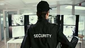 Security guard monitoring security cameras in control room Premium Stock Video Footage